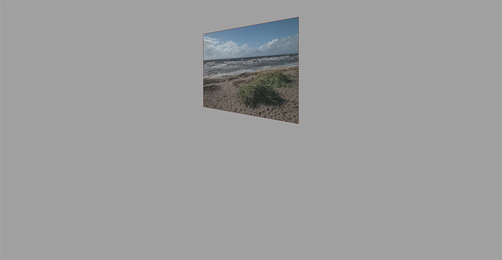 A skewed image with a photo inside of a sandy dune-y beach (its Scotland)
